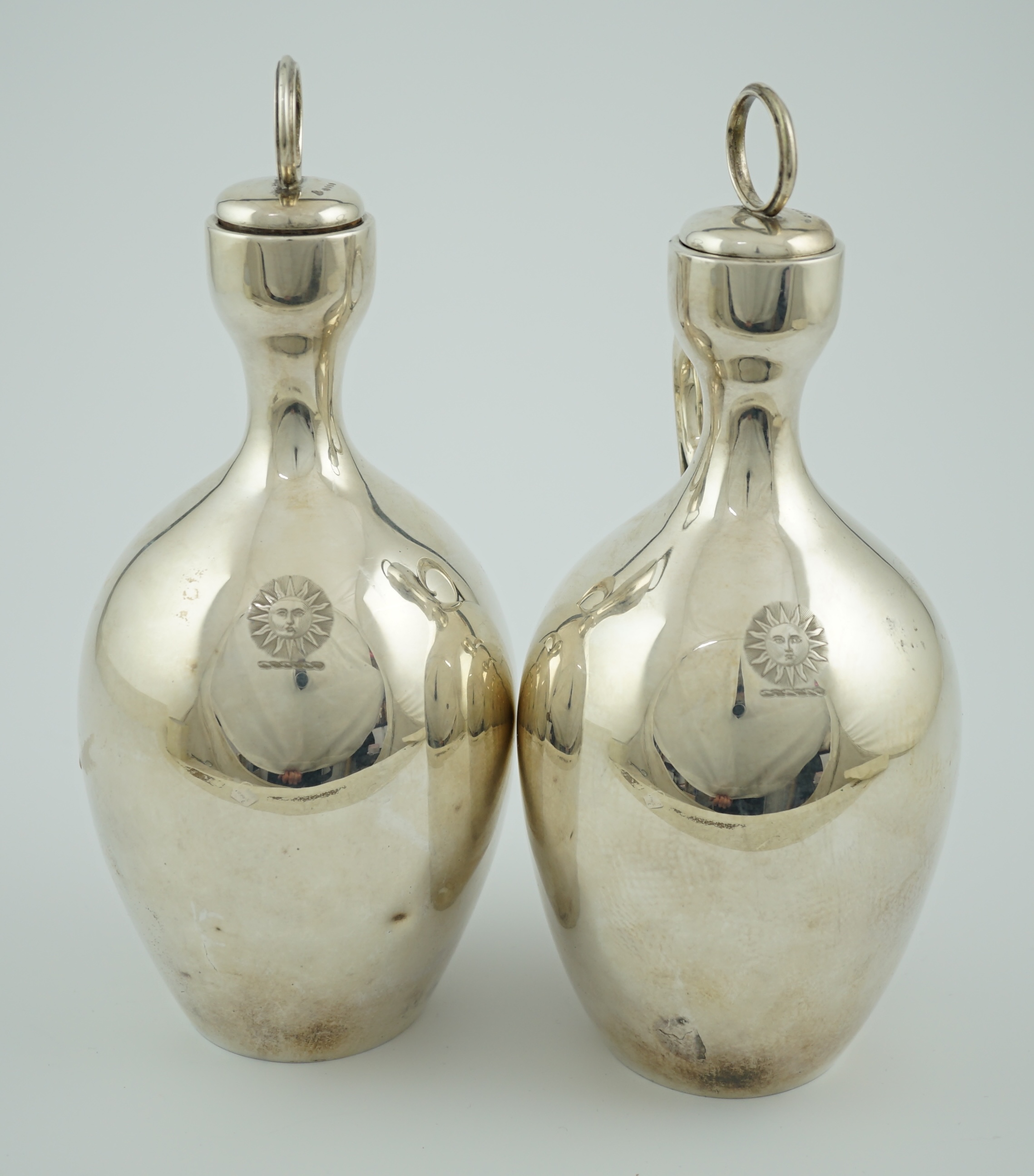 A pair of Victorian silver single handled ovoid water/wine jugs with stoppers, by R & S Garrard & Co